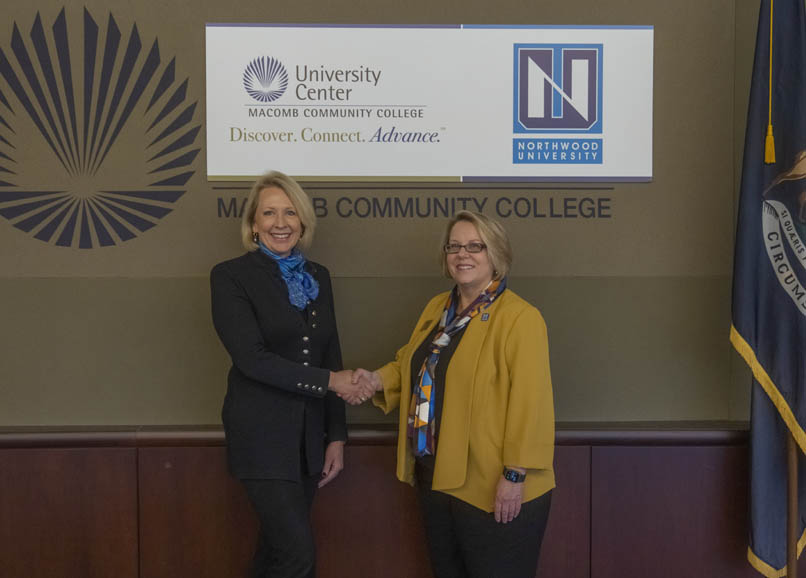 Kristin Stehouwer, Ph.D., provost and vice president of Academics at Northwood University (left) and Leslie Kellogg, Ed.D., provost and vice president of the Learning Unit, Macomb Community College (right) shake hands after signing the articulation agreements